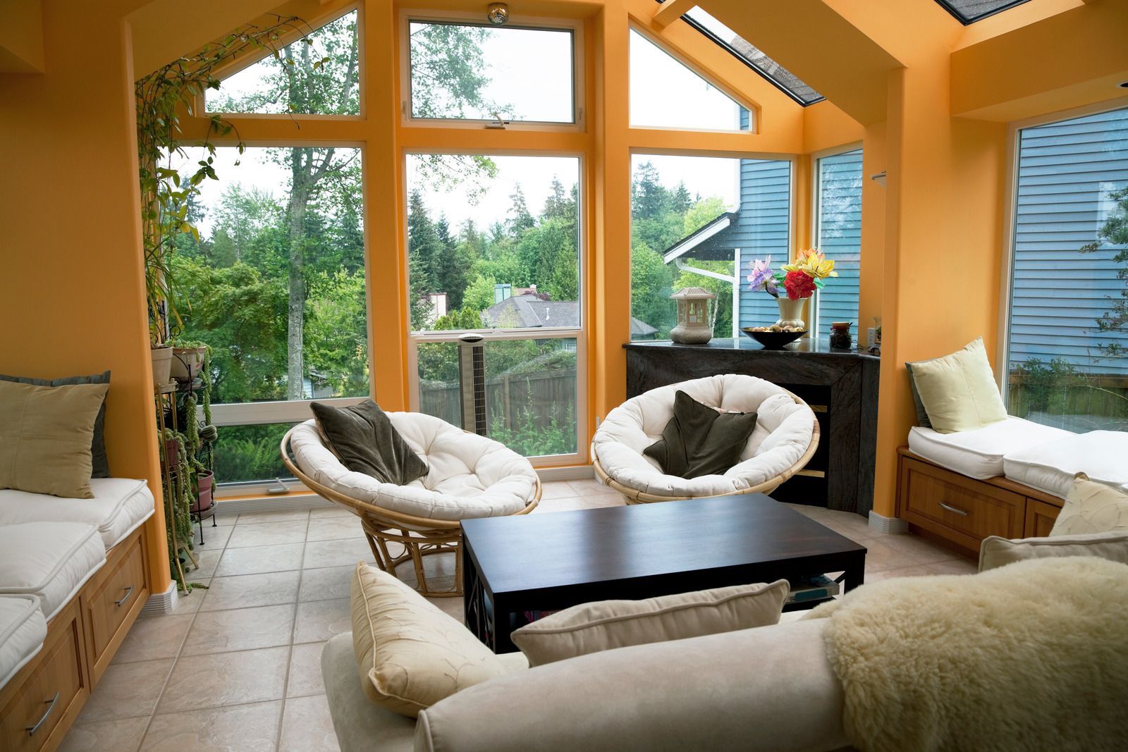 A living room with a lot of windows and chairs