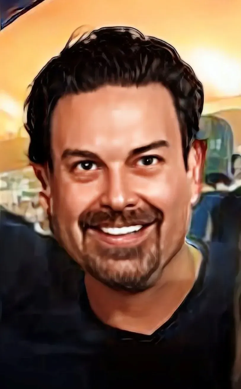Picture of Erik Fleming with a mustache and beard smiling for the camera