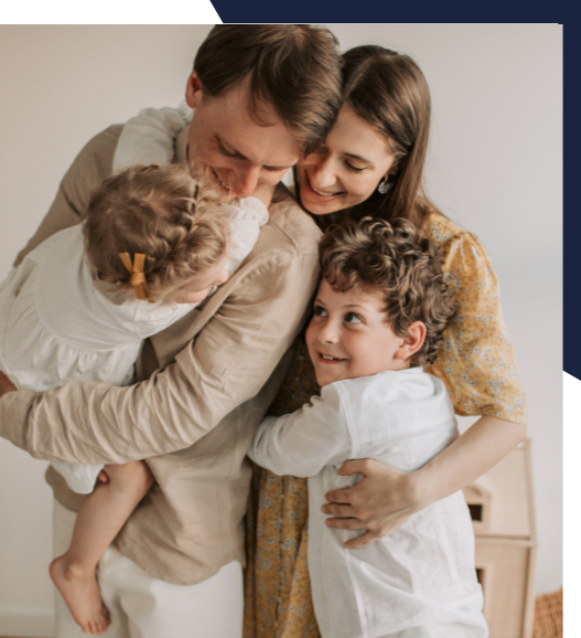 A family is posing for a picture while a man is holding a baby.