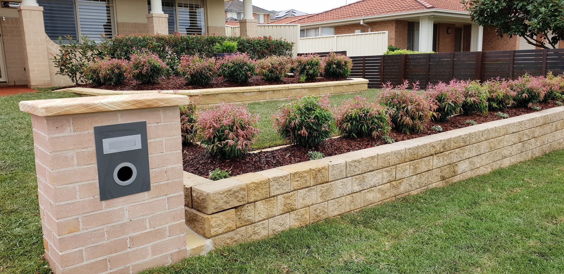 Stone Tiered Garden With Shrubs — Total Perfection In Kariong, NSW