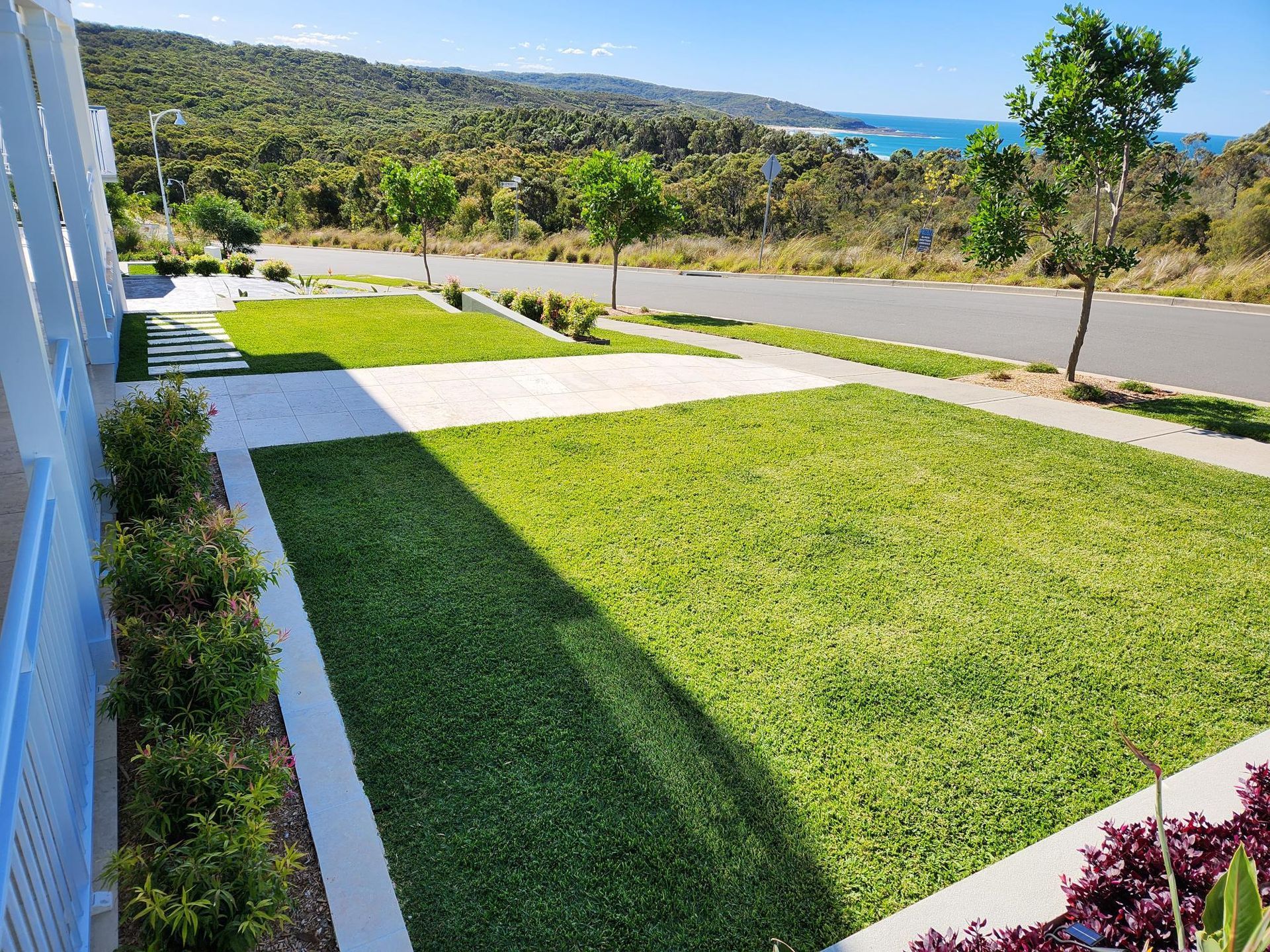 Lush Green Lawn and Gardens Border a Street, with A Coastal View — Total Perfection In Kincumber, NSW