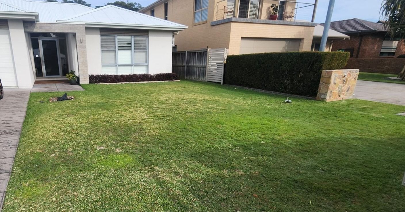Green Lawn in Front of a Beige House — Total Perfection In Kincumber, NSW