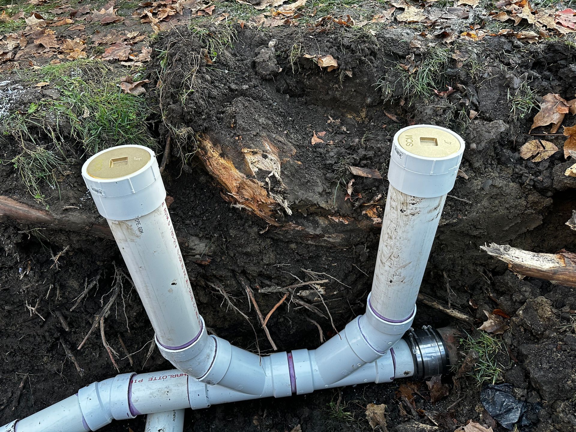 A pipe is being installed in a hole in the ground.