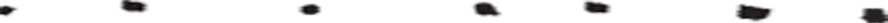 Tiny horizontal black and white abstract strip with scattered colored blocks on a white background
