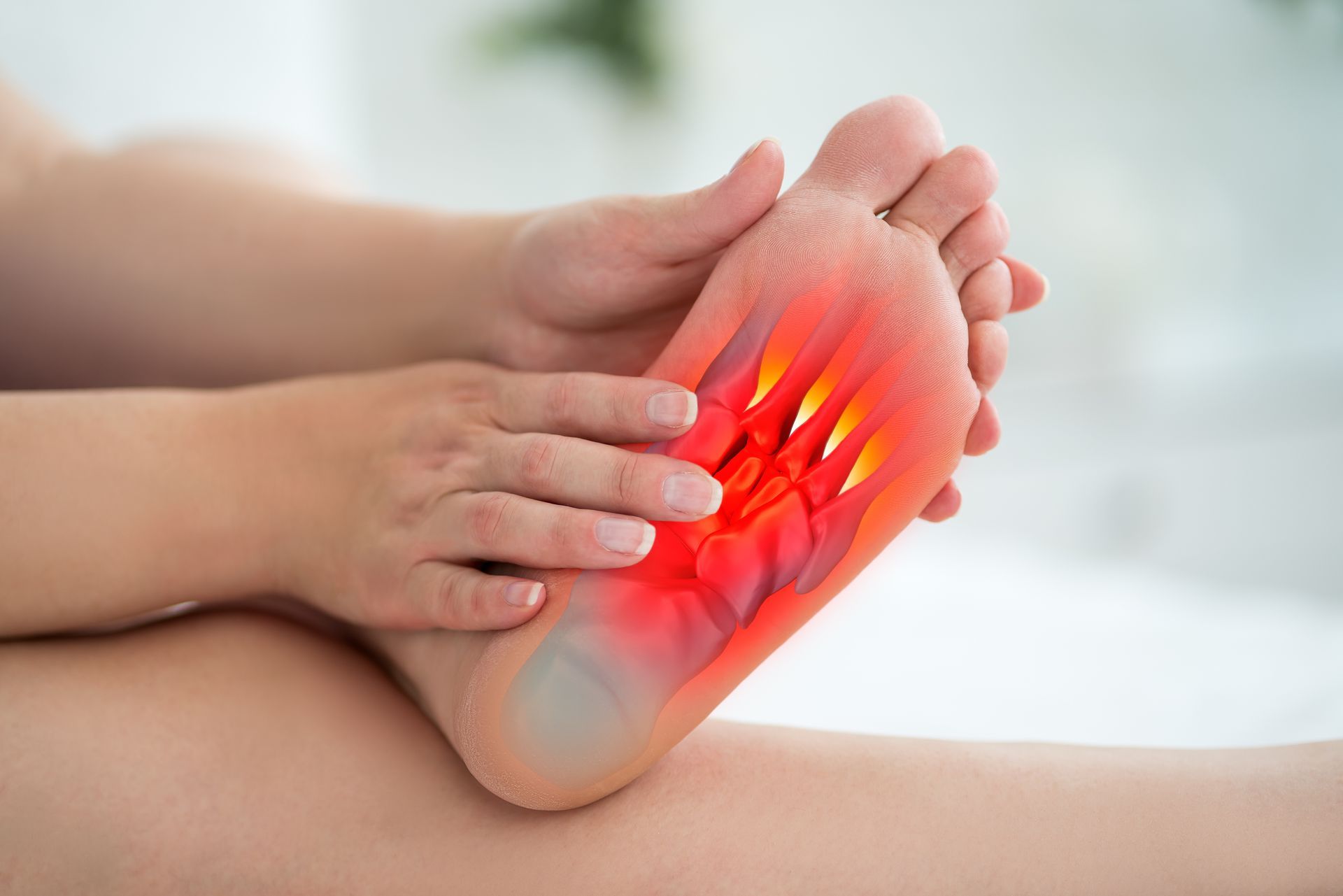 A person is holding their foot in pain.