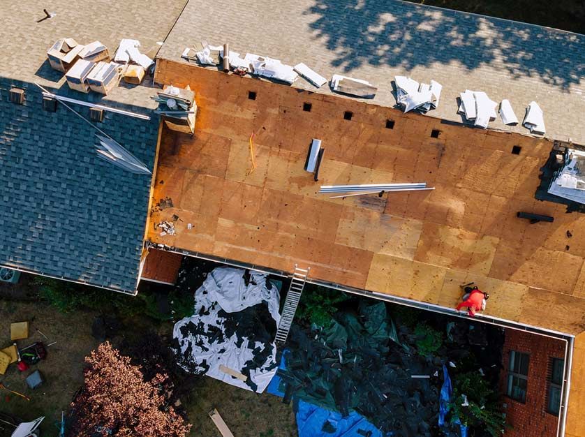 An aerial view of a roof that is being repaired