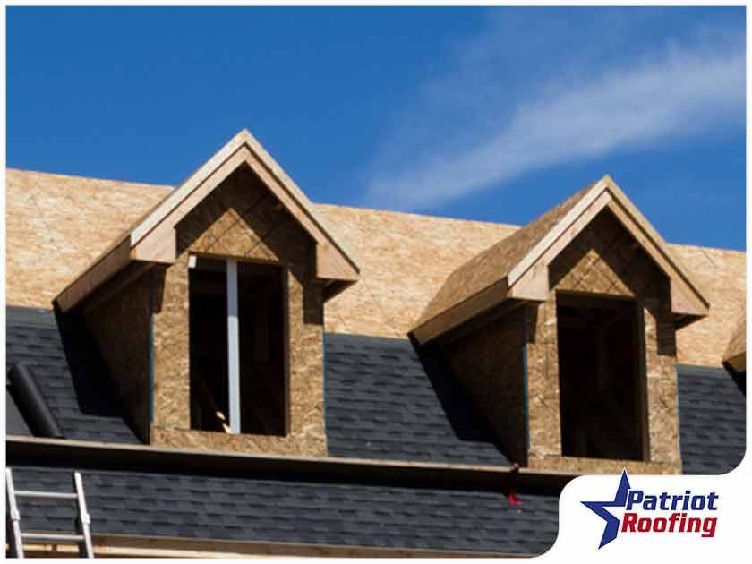 A picture of a roof with a patriot roofing logo in the corner