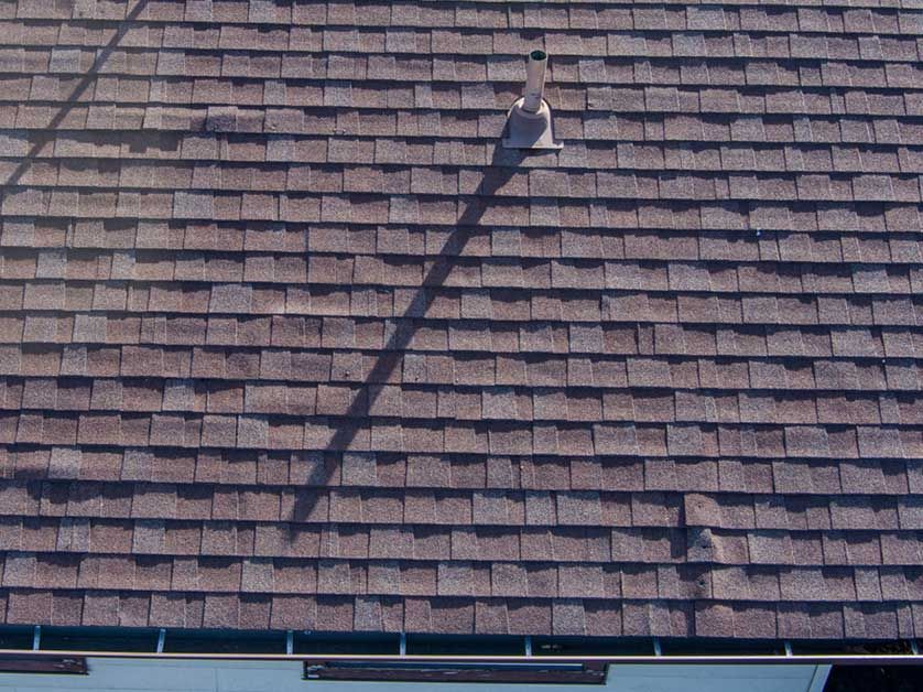 A close up of a roof with a chimney on it