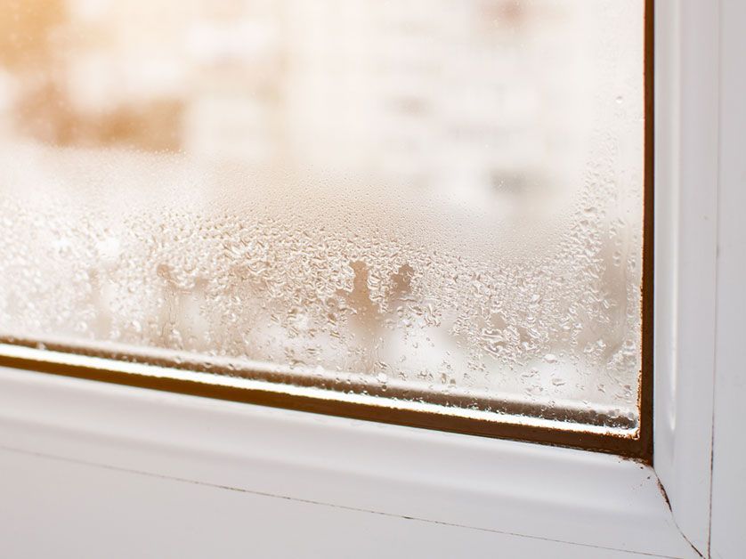 A close up of a window with condensation on it.