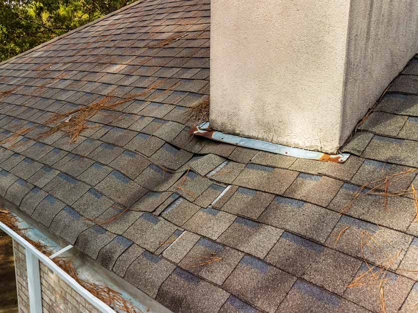 A roof with a chimney on top of it and a gutter.