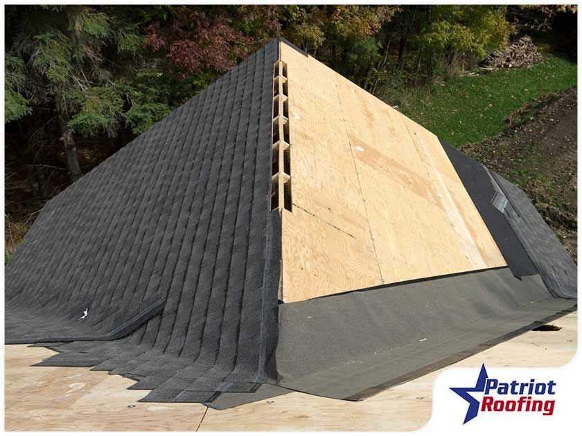 A pyramid shaped roof is being built by patriot roofing