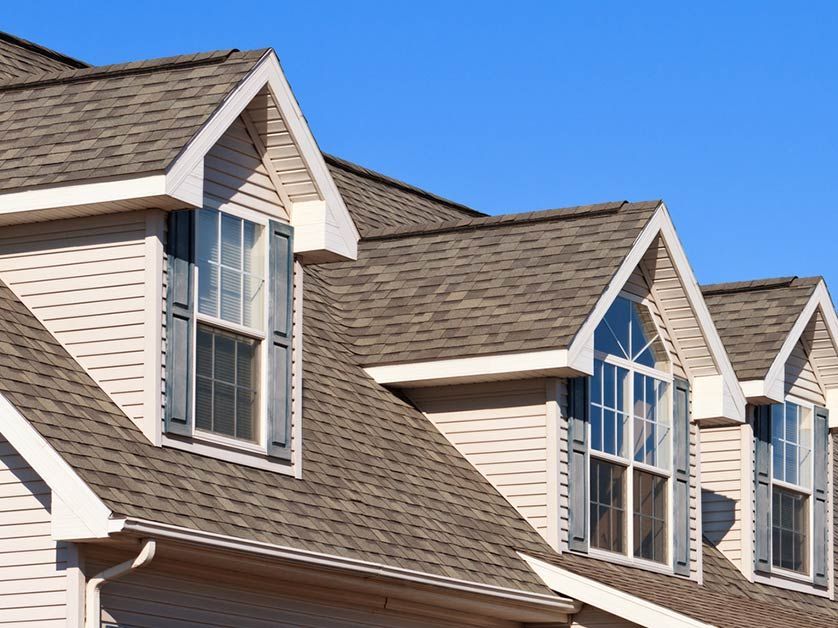 The roof of a house with a blue sky in the background