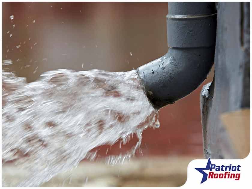 Water is coming out of a drain pipe.