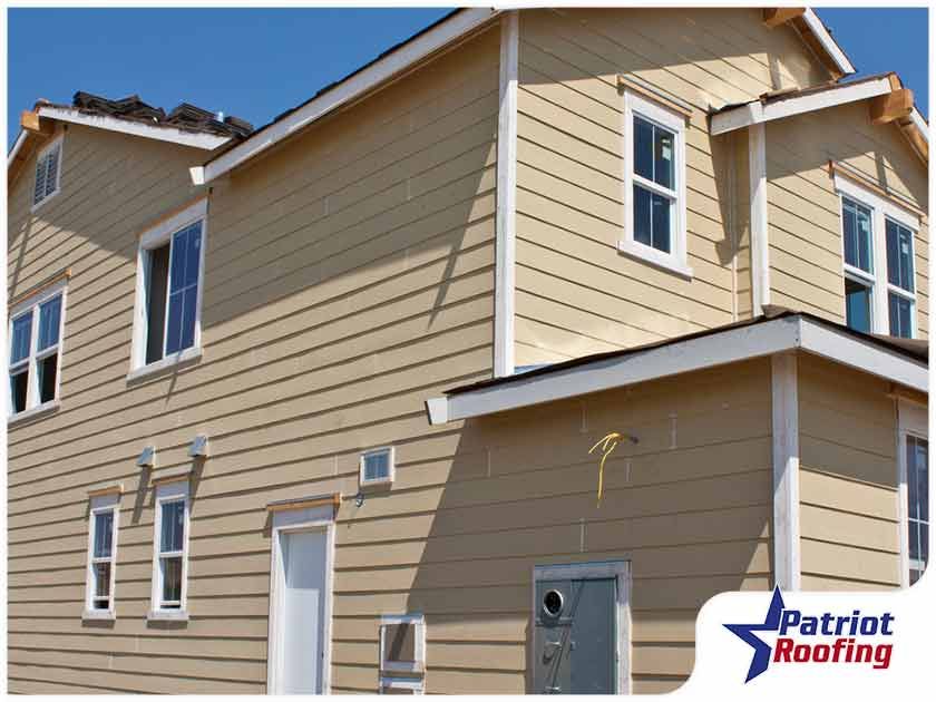 A picture of a house with patriot roofing in the corner