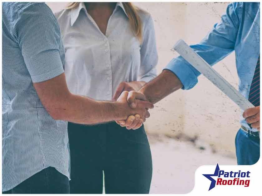 A man and a woman are shaking hands with each other.
