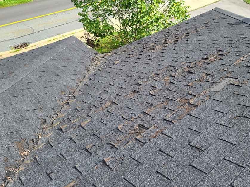 A close up of a roof with a lot of shingles on it.