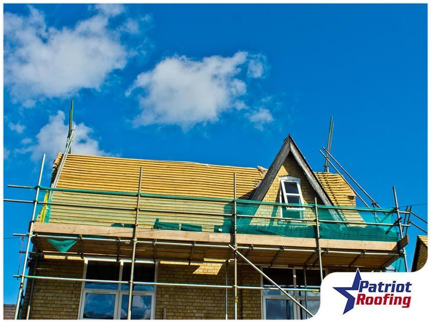 A house is being built with scaffolding on the roof.