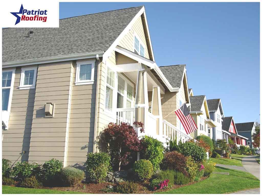 A row of houses with patriot roofing in the corner