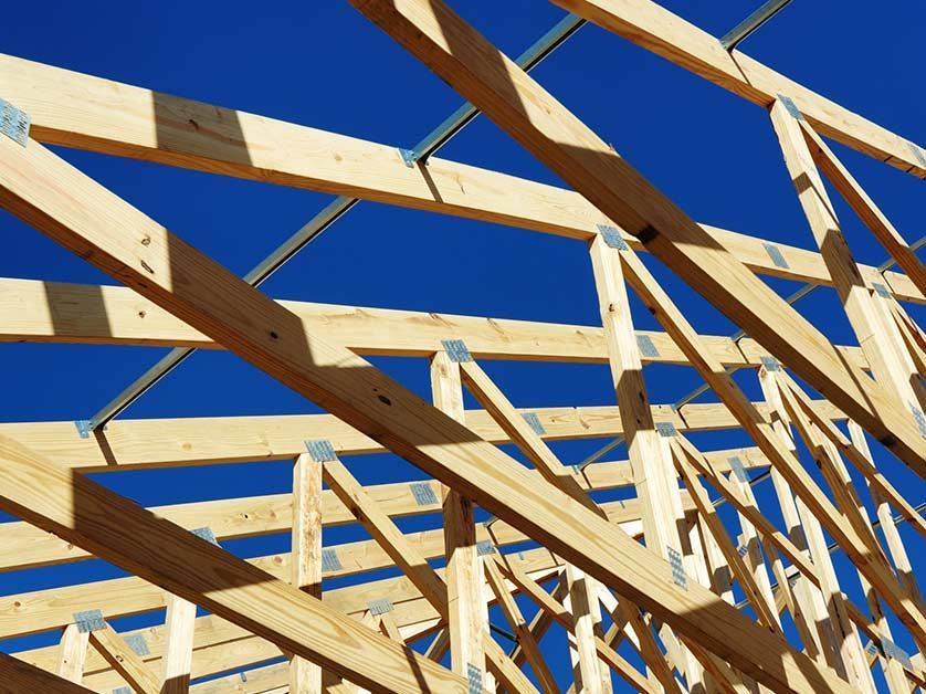A wooden structure under construction with a blue sky in the background