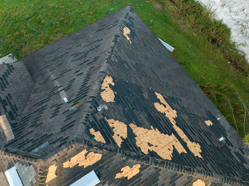 An aerial view of a roof that has been damaged by a storm.