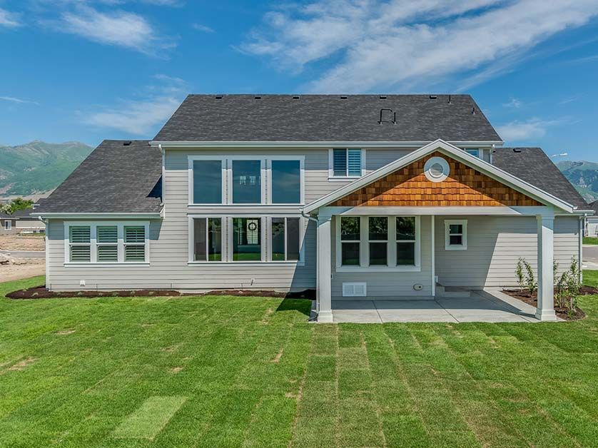 A large house with a large lawn in front of it.
