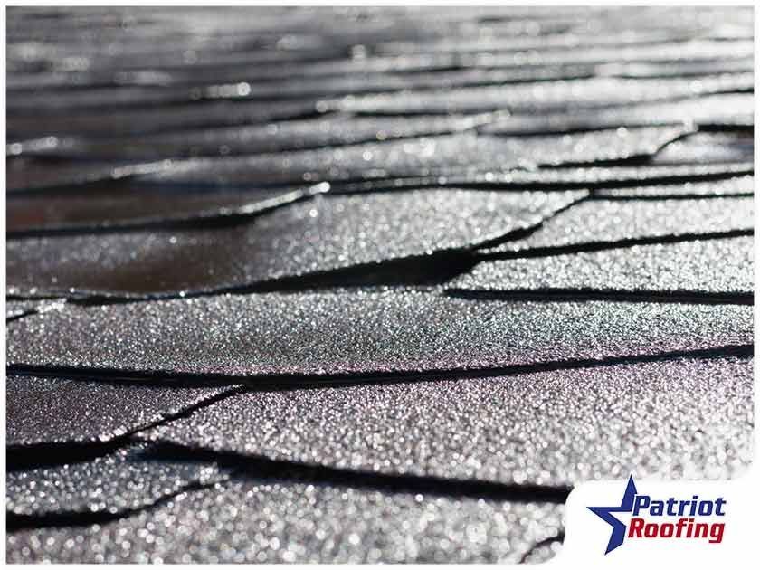 A picture of a roof with patriot roofing in the corner