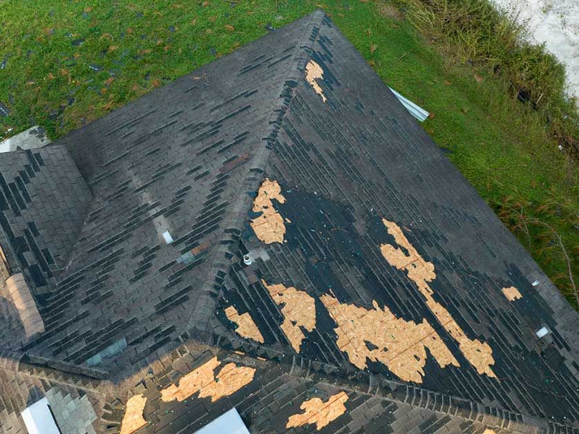 An aerial view of a roof that has been damaged by a storm.