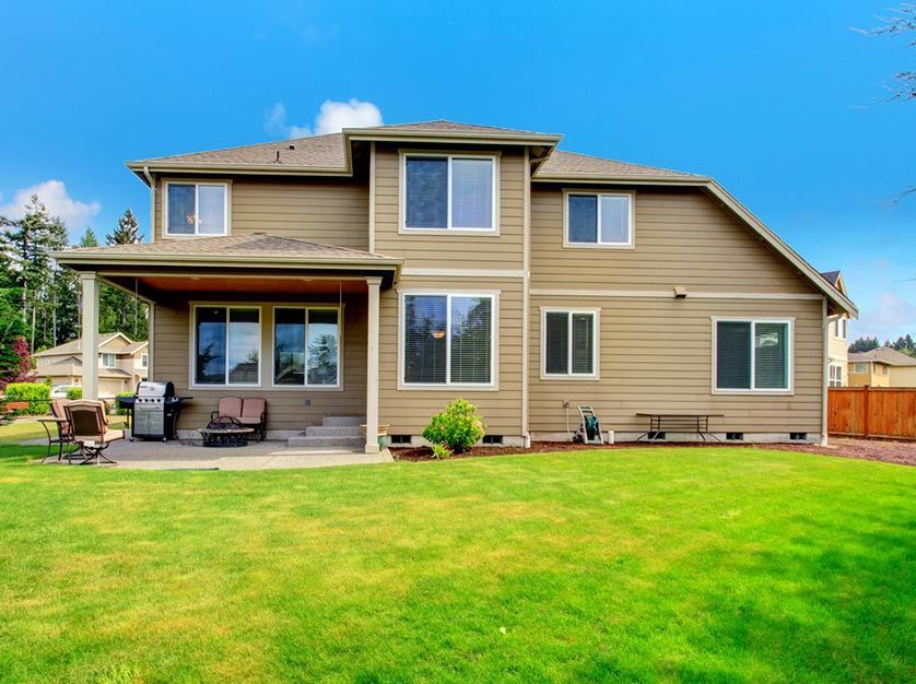 A large house with a large lawn in front of it.