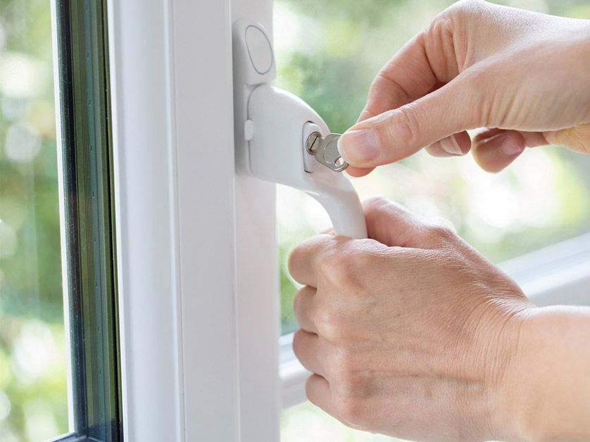 A person is opening a window with their hands.