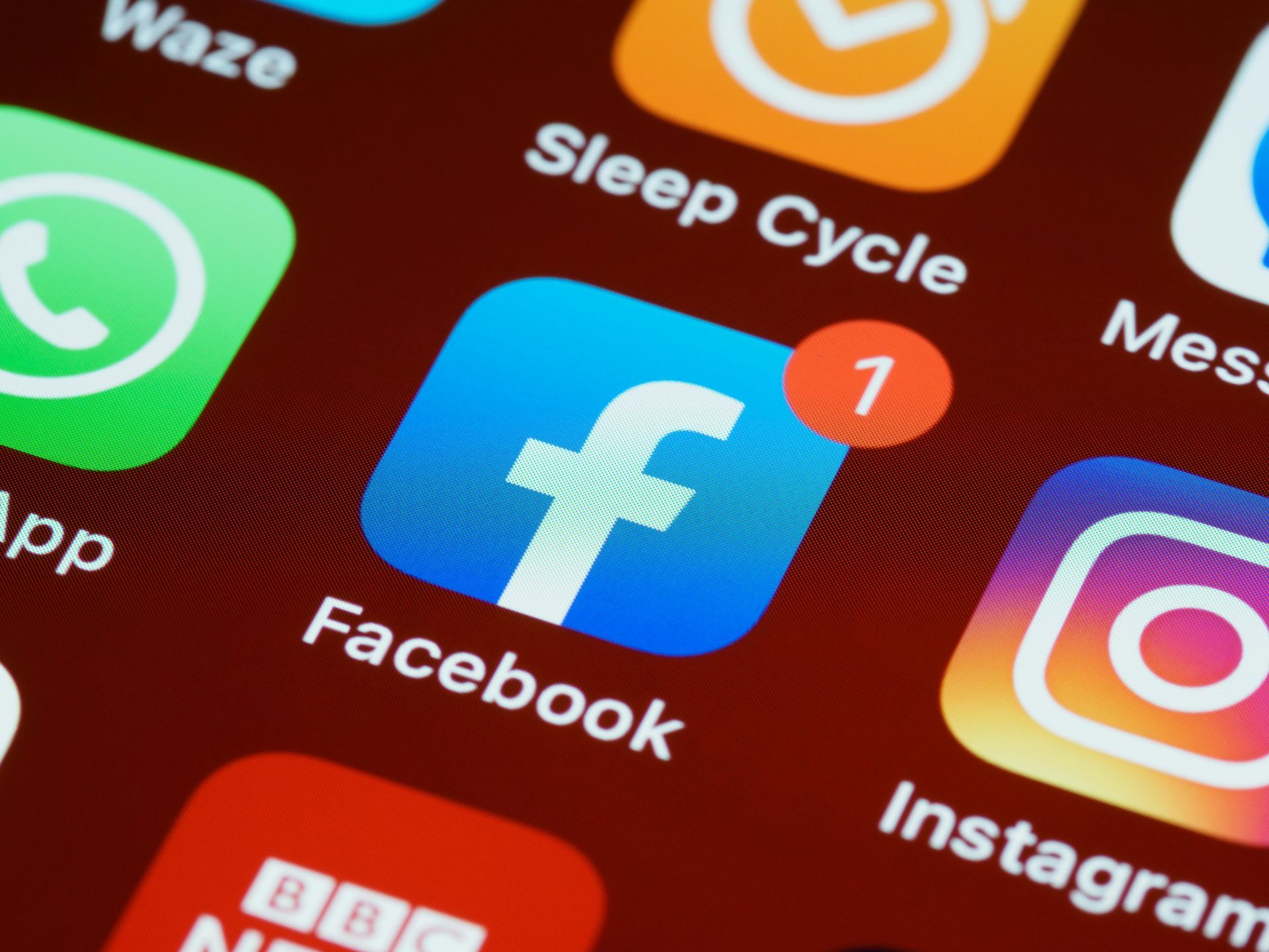 Close-up of smartphone app icons, including Facebook and Instagram, on a screen