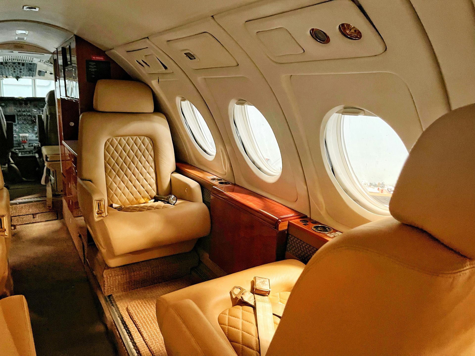 The inside of an airplane with a lot of seats and windows