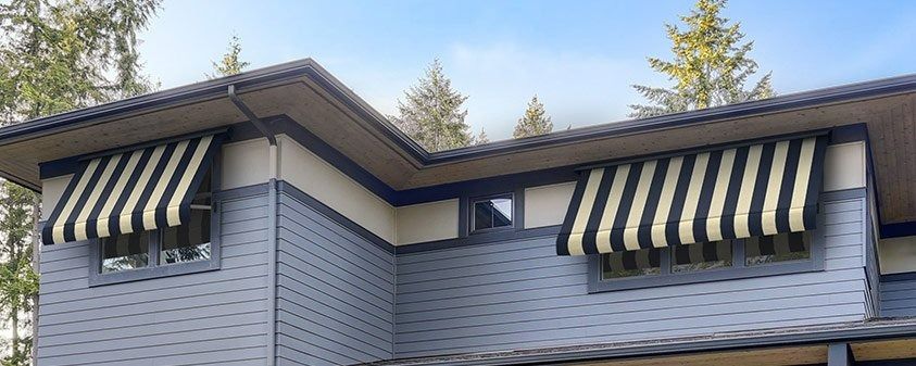 A House With a Striped Awning on the Windows — Simply Smarter Blinds in Medowie, NSW