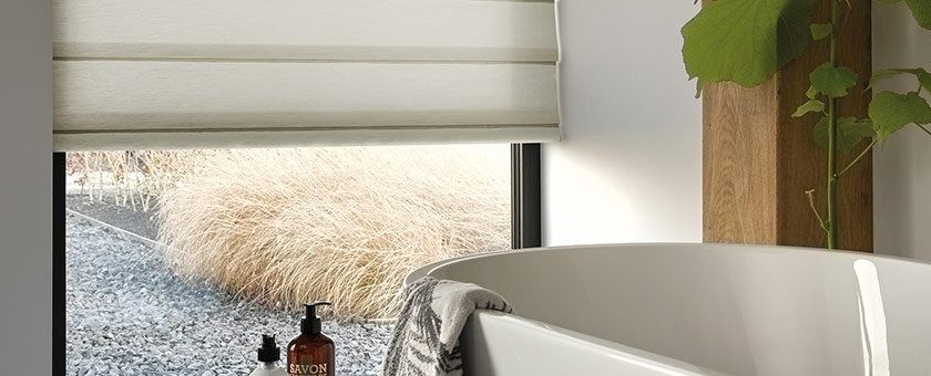 A Bathroom With a Bathtub and a Window With Blinds — Simply Smarter Blinds in Medowie, NSW