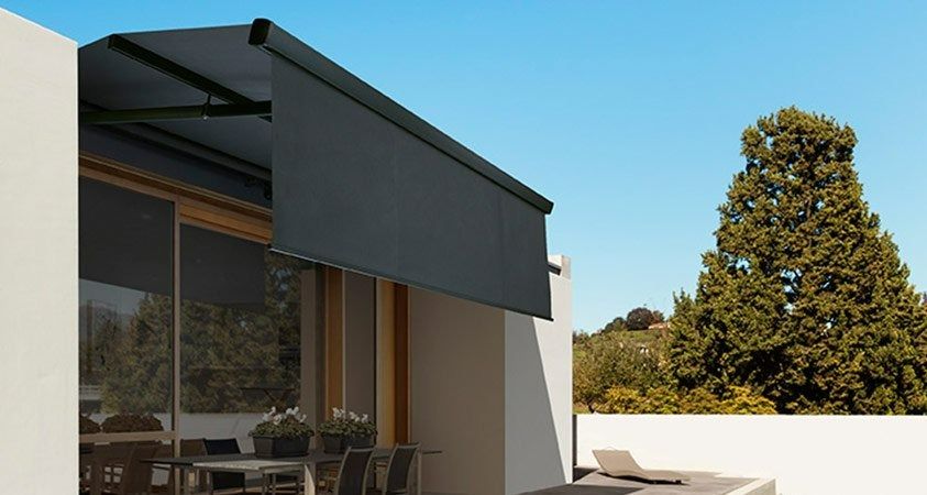 A Patio With a Table and Chairs Under an Awning — Simply Smarter Blinds in Nelson Bay, NSW