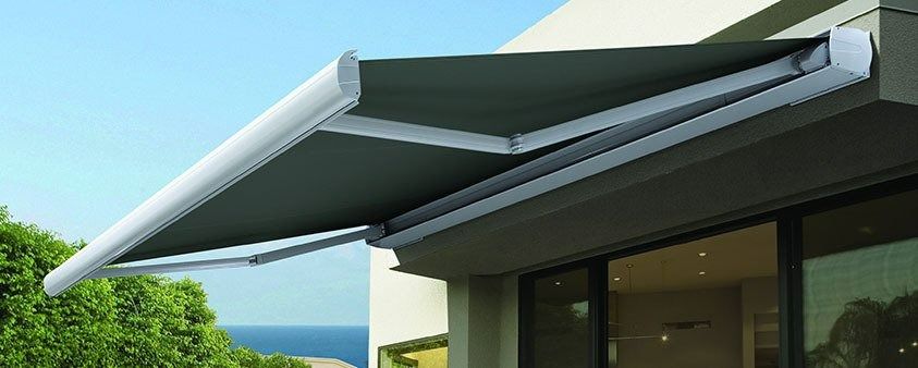 A White Awning is Sitting on the Side of a Building — Simply Smarter Blinds in Medowie, NSW