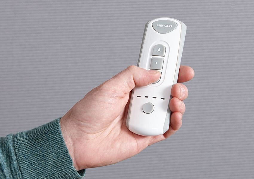 A Person is Holding a Remote Control in Their Hand — Simply Smarter Blinds in Nelson Bay, NSW