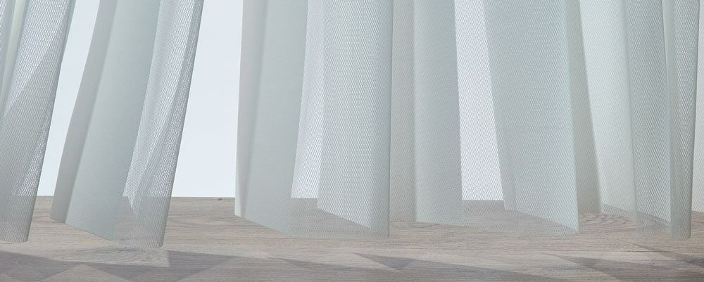 A Close Up of a White Curtain Hanging on a Window — Simply Smarter Blinds in Medowie, NSW