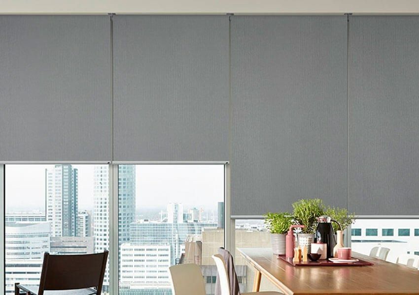 A Dining Room With a Table and Chairs and a Large Window — Simply Smarter Blinds in Tea Gardens, NSW