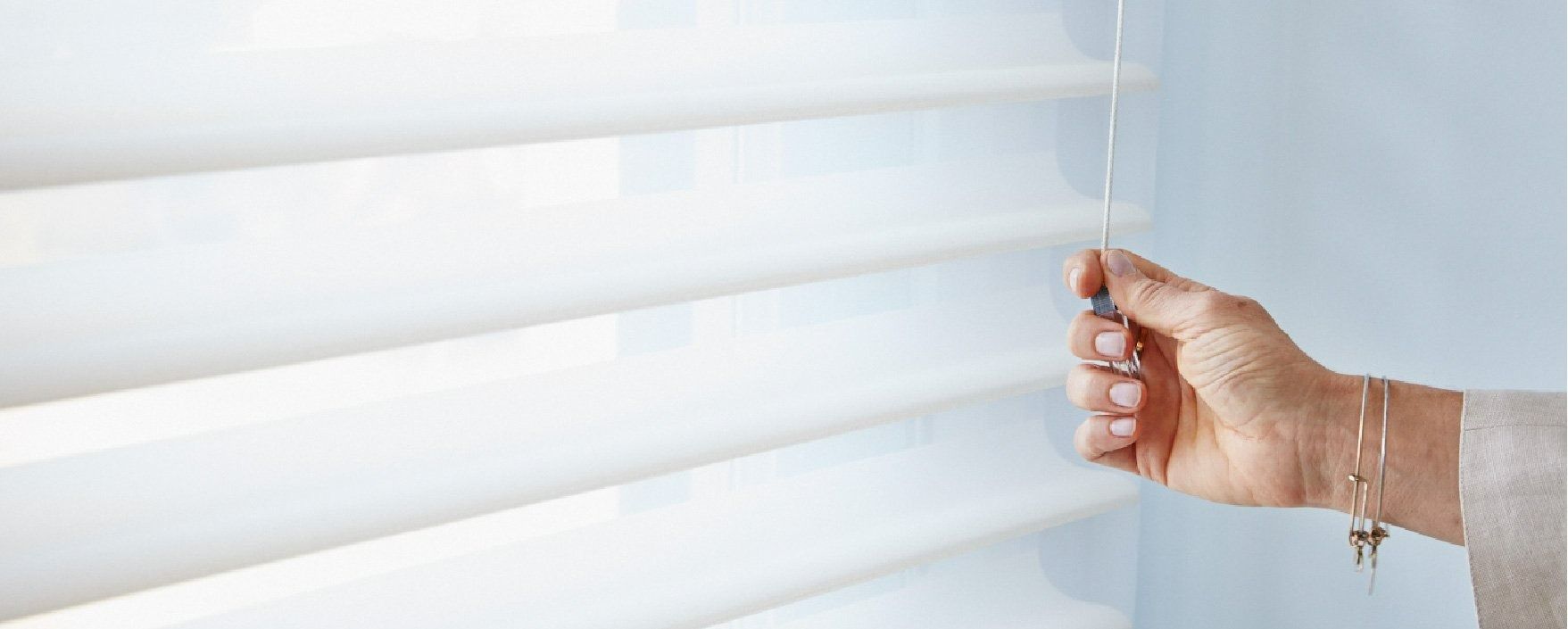 A Person is Holding a Remote Control to Open a Window Blind — Simply Smarter Blinds in North Arm Cove, NSW