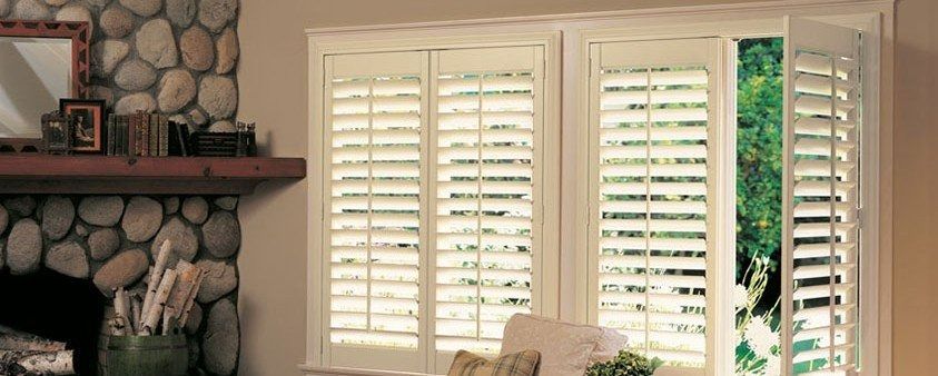 A Living Room With a Fireplace and Shutters on the Windows — Simply Smarter Blinds in North Arm Cove, NSW