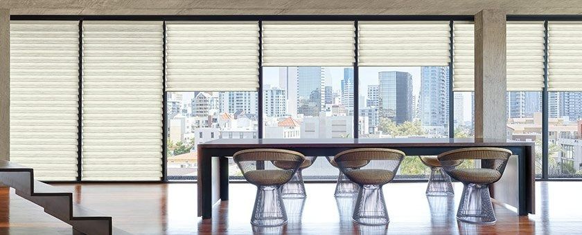 A Dining Room With a Table and Chairs in Front of a Large Window — Simply Smarter Blinds in Tea Gardens, NSW