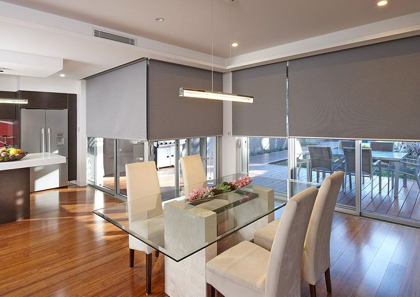 A Dining Room With a Glass Table and White Chairs — Simply Smarter Blinds in Hawks Nest, NSW
