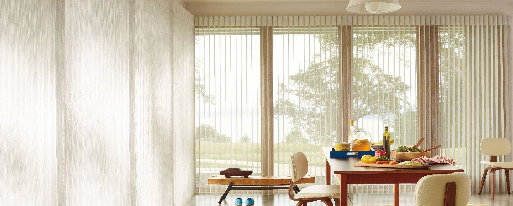 A Dining Room With a Table and Chairs and Sliding Glass Doors — Simply Smarter Blinds in Hawks Nest, NSW