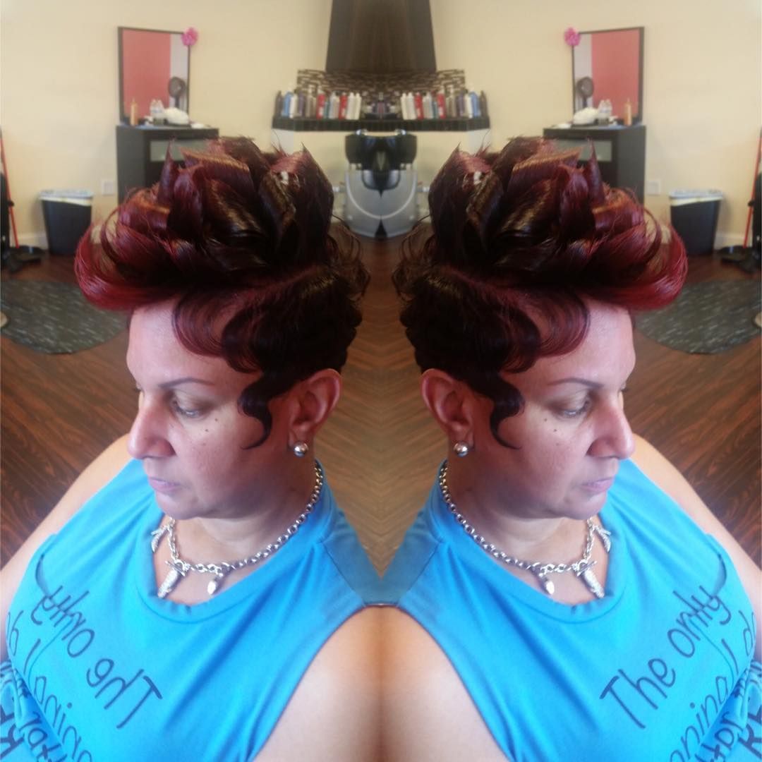 Person with styled red hair and blue tank top, shown as a mirrored double portrait indoors.