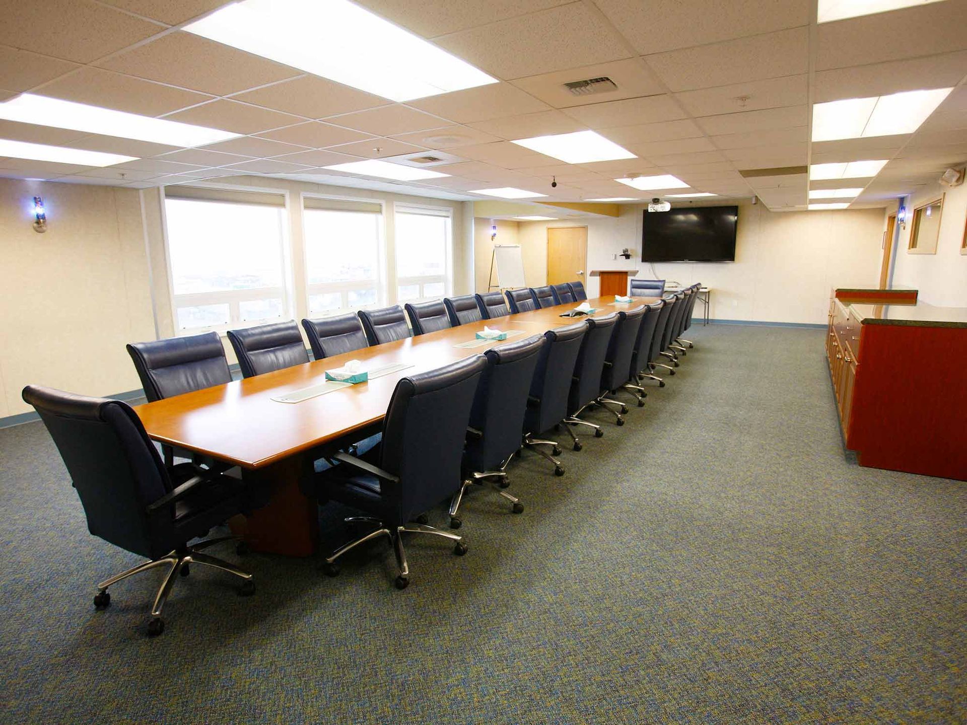 A conference room with a long table and chairs