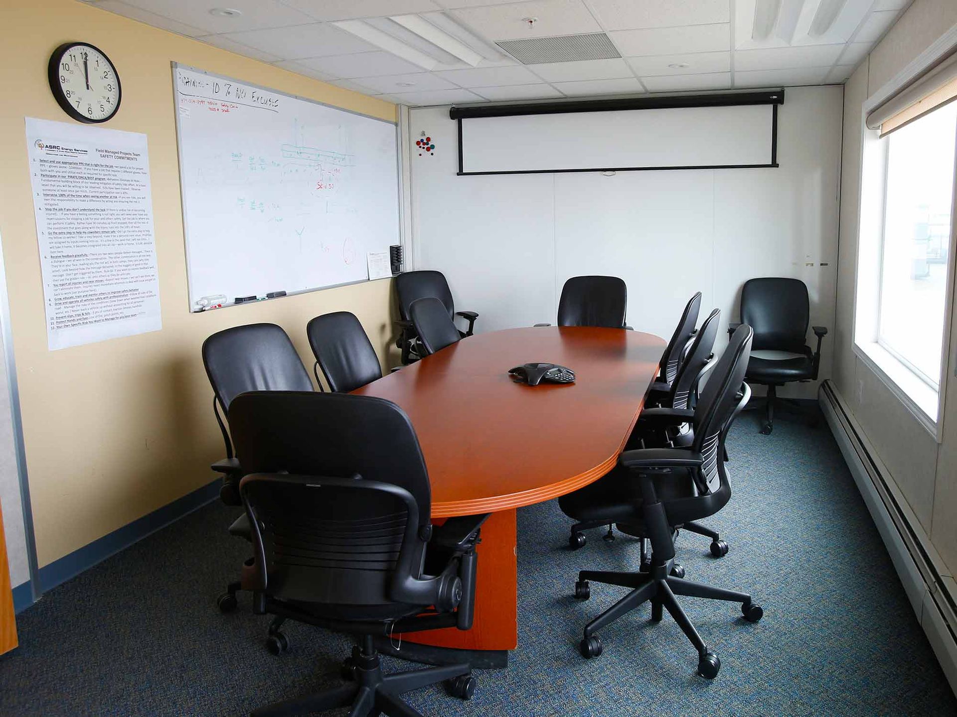 A conference room with a long table and chairs