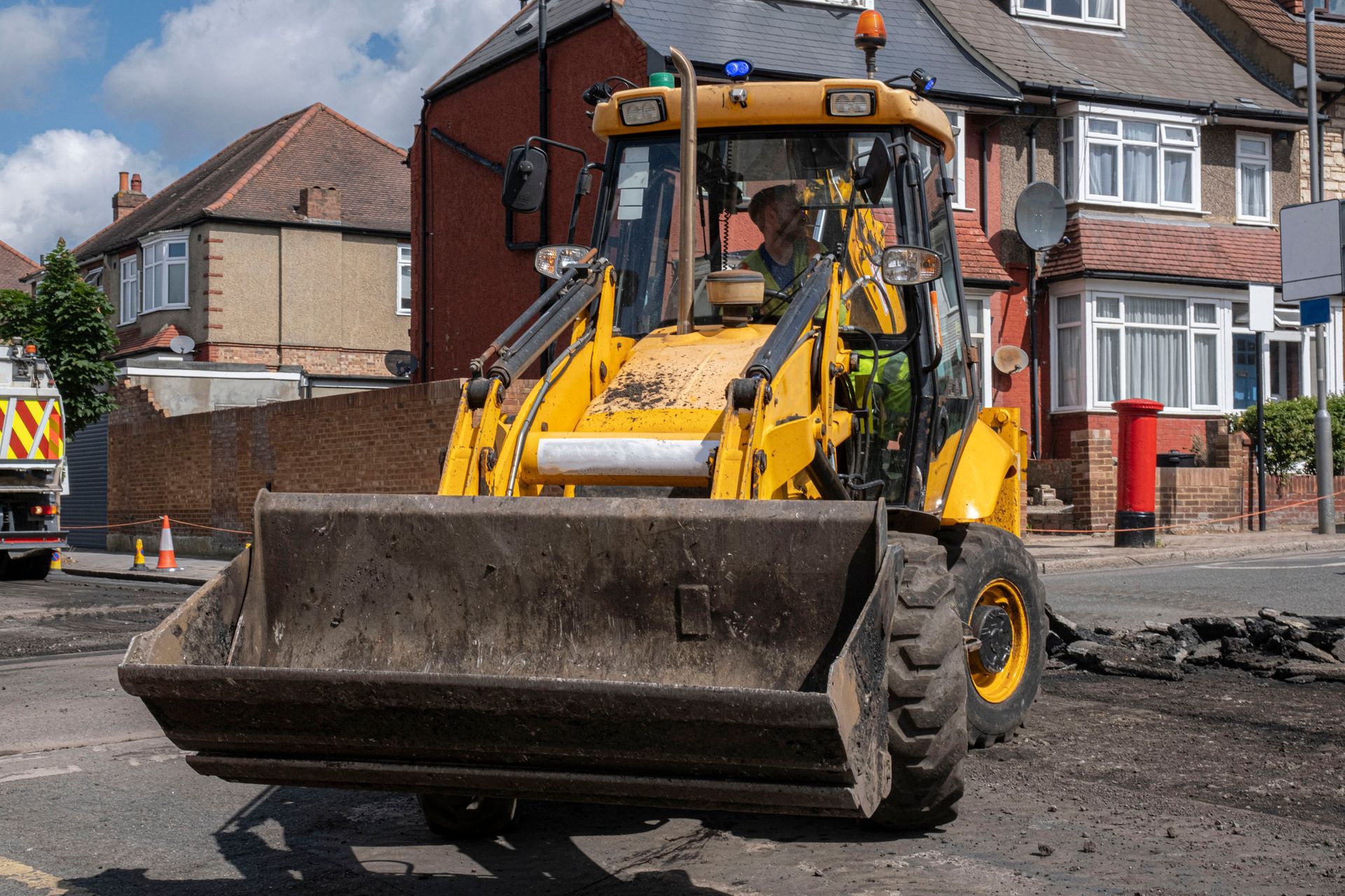 A yellow bulldozer is parked on the side of the road