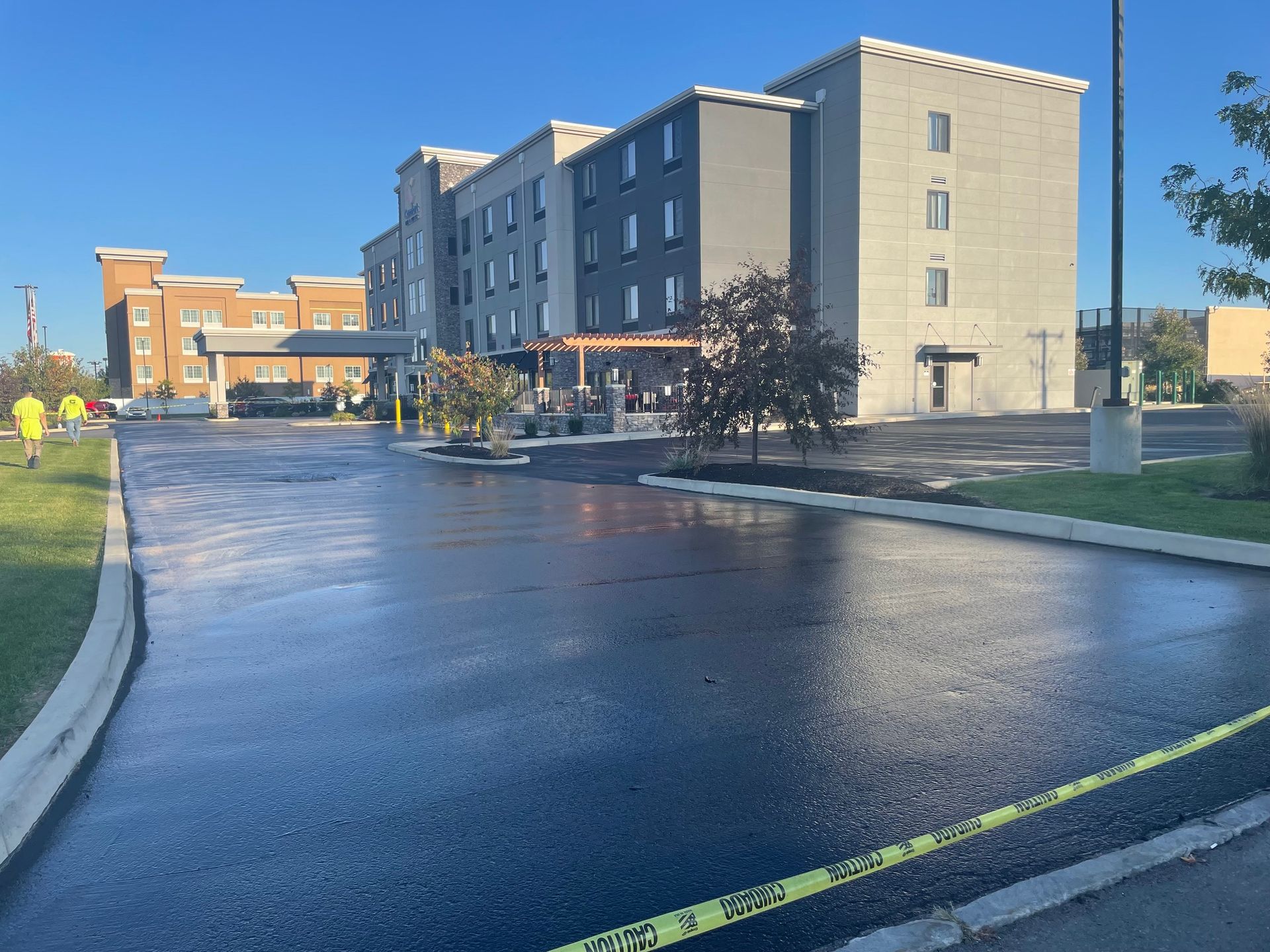 An empty parking lot in front of a large building.