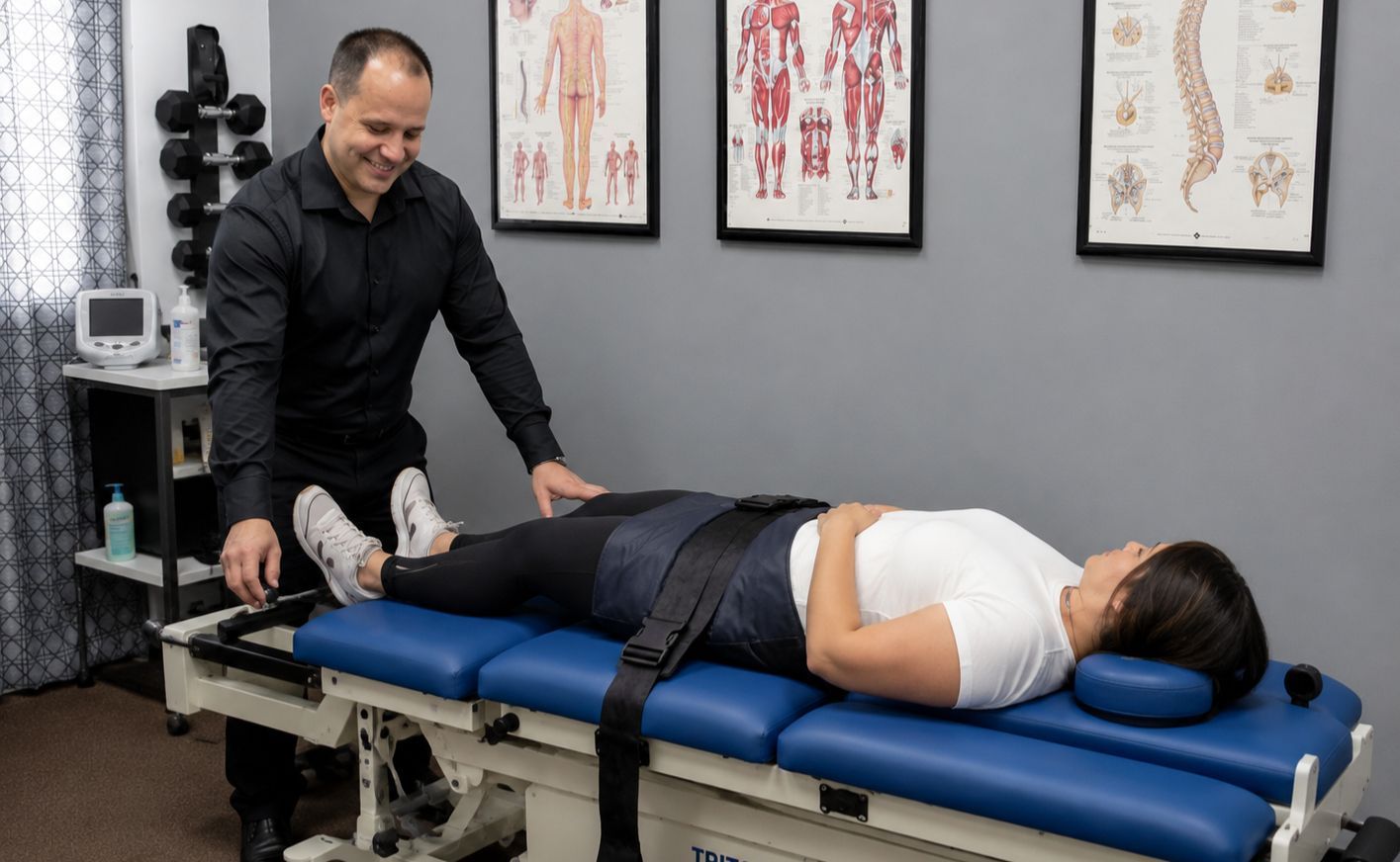 Chiropractor adjusting a patient lying on a treatment table for Decompression therapy in Orlando at Sunshine State Medical, inc