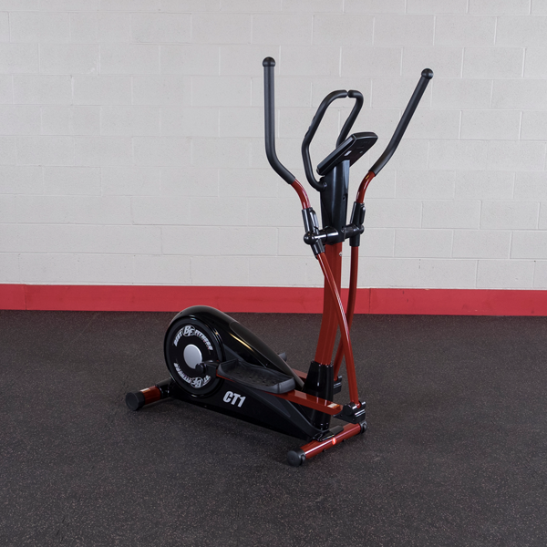 Black and red elliptical exercise machine on a gym floor against a white wall